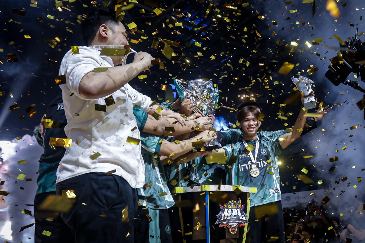 Aurora lifting the MPL Philippines trophy amid gold confetti